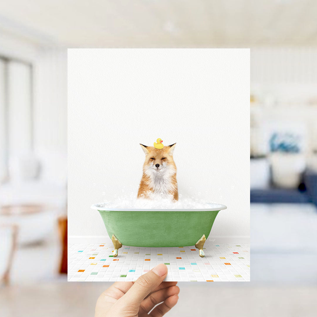 A fox is sitting in a green bathtub filled with bubbles, with a rubber duck perched on its head.