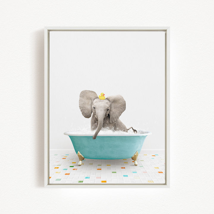 A baby elephant sitting in a blue bathtub, with a yellow rubber duck on its head, against a white background.