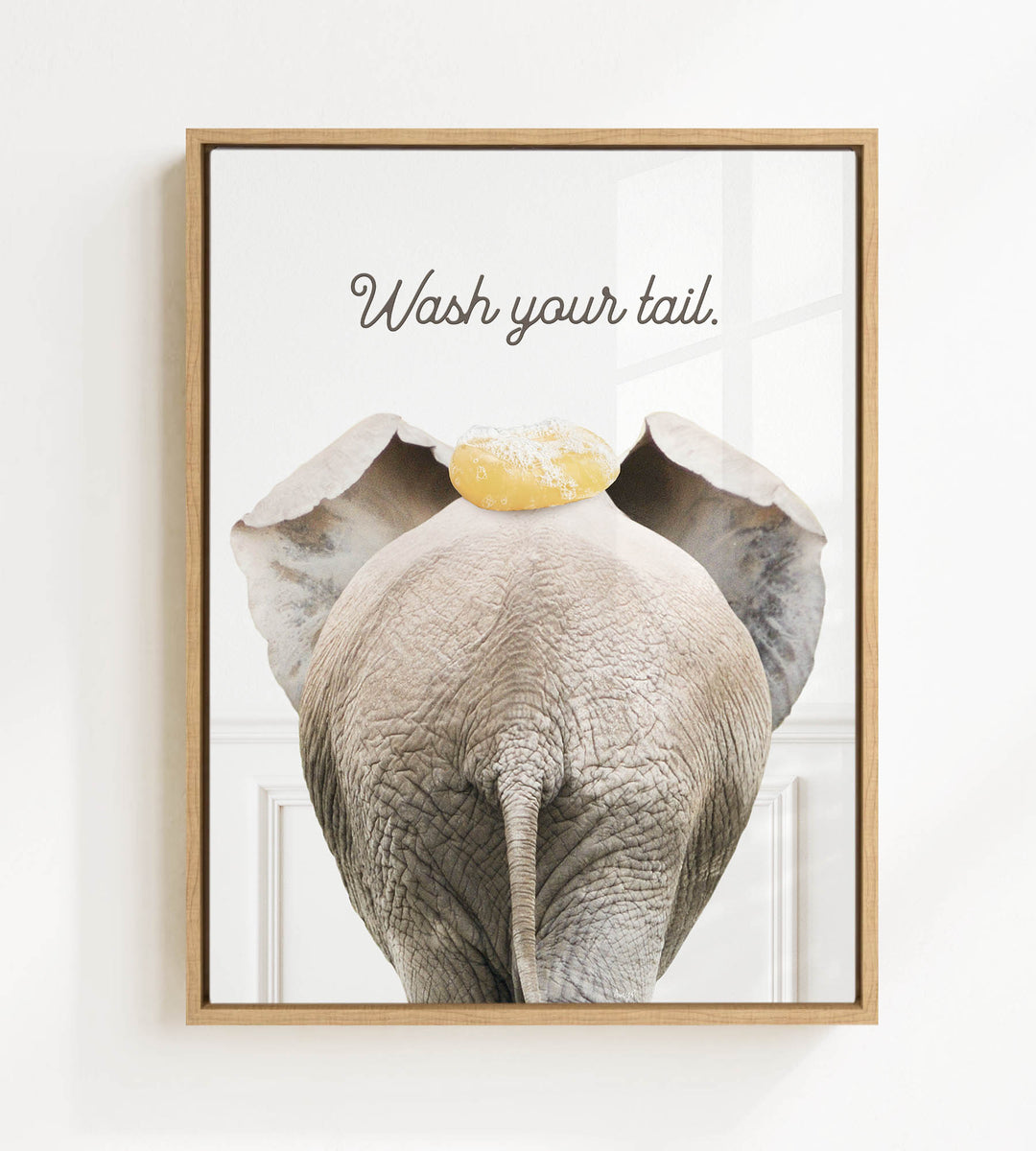 an elephant with a yellow object on its head, accompanied by the text "Wash your tail."