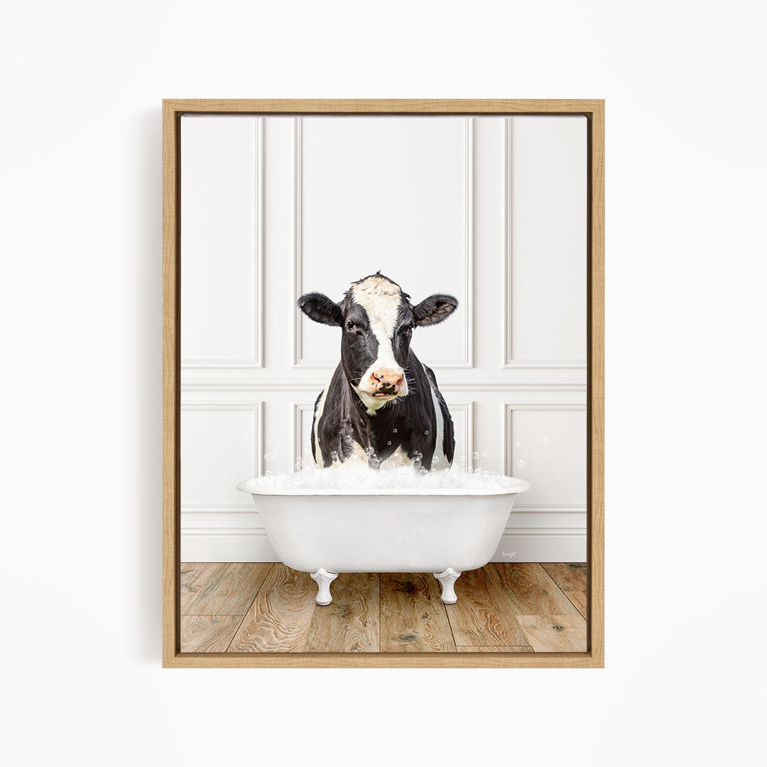 A black and white cow is standing in a white bathtub filled with water, creating a whimsical and humorous scene.
