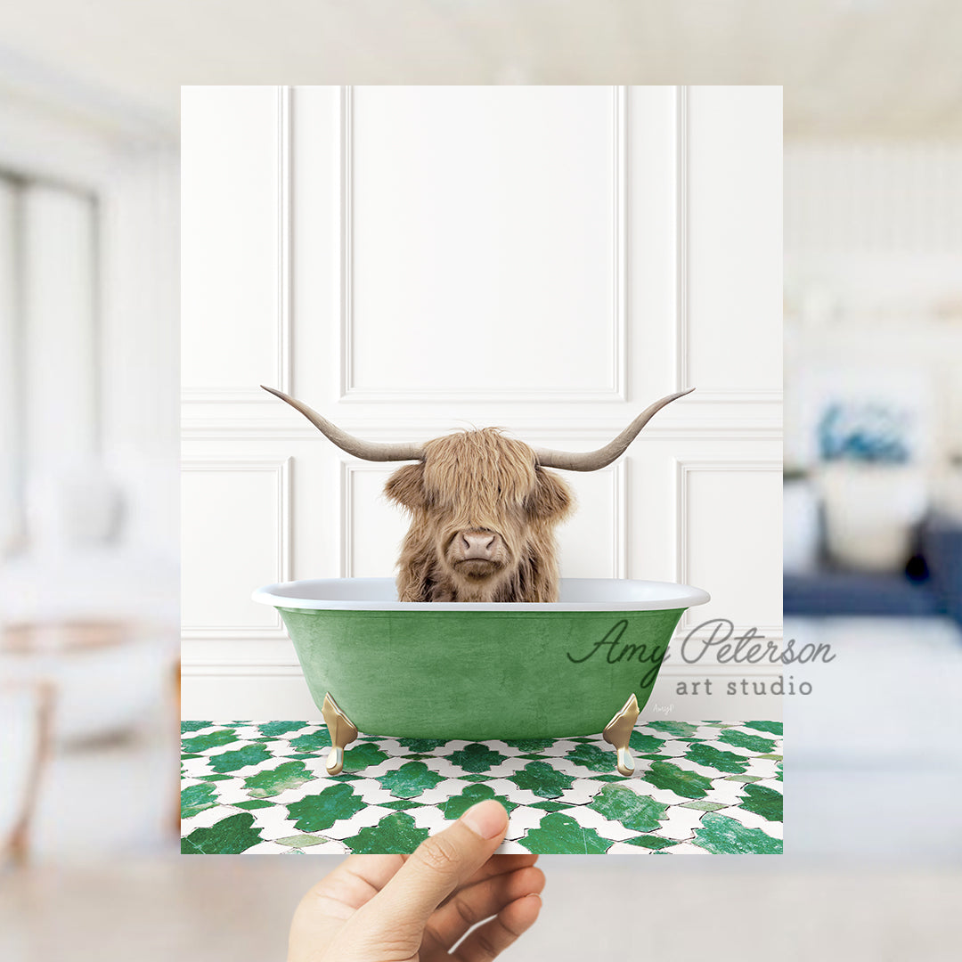 a hand holding a card with a picture of a cow in a bathtub