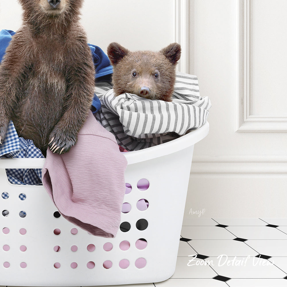 A laundry basket containing clothes and a stuffed bear.
