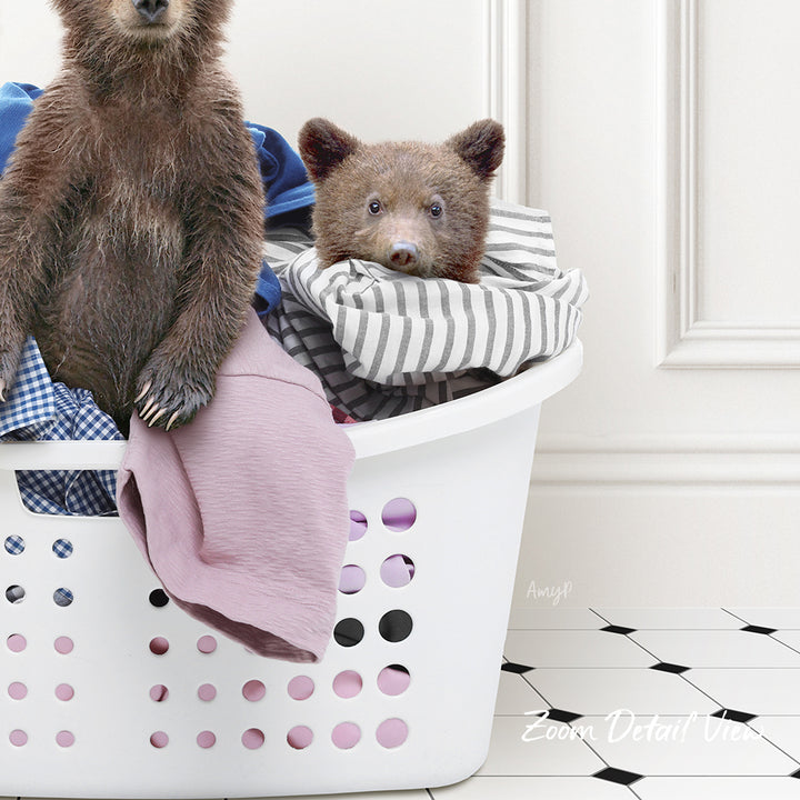 A laundry basket containing clothes and a stuffed bear.