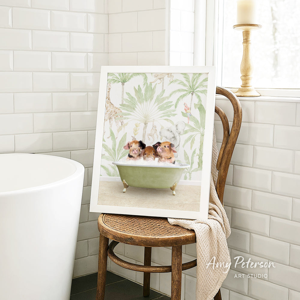A framed illustration of two small animals, likely dogs, sitting in a bathtub is displayed on a wooden chair in a bathroom setting.