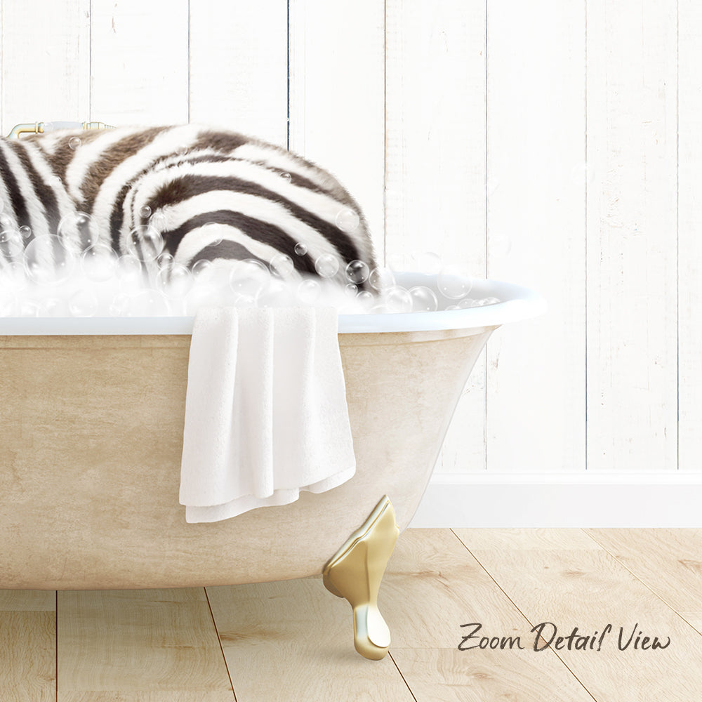 A zebra lying in a bathtub filled with bubbles, with a towel draped over the side and a wooden floor visible in the background.