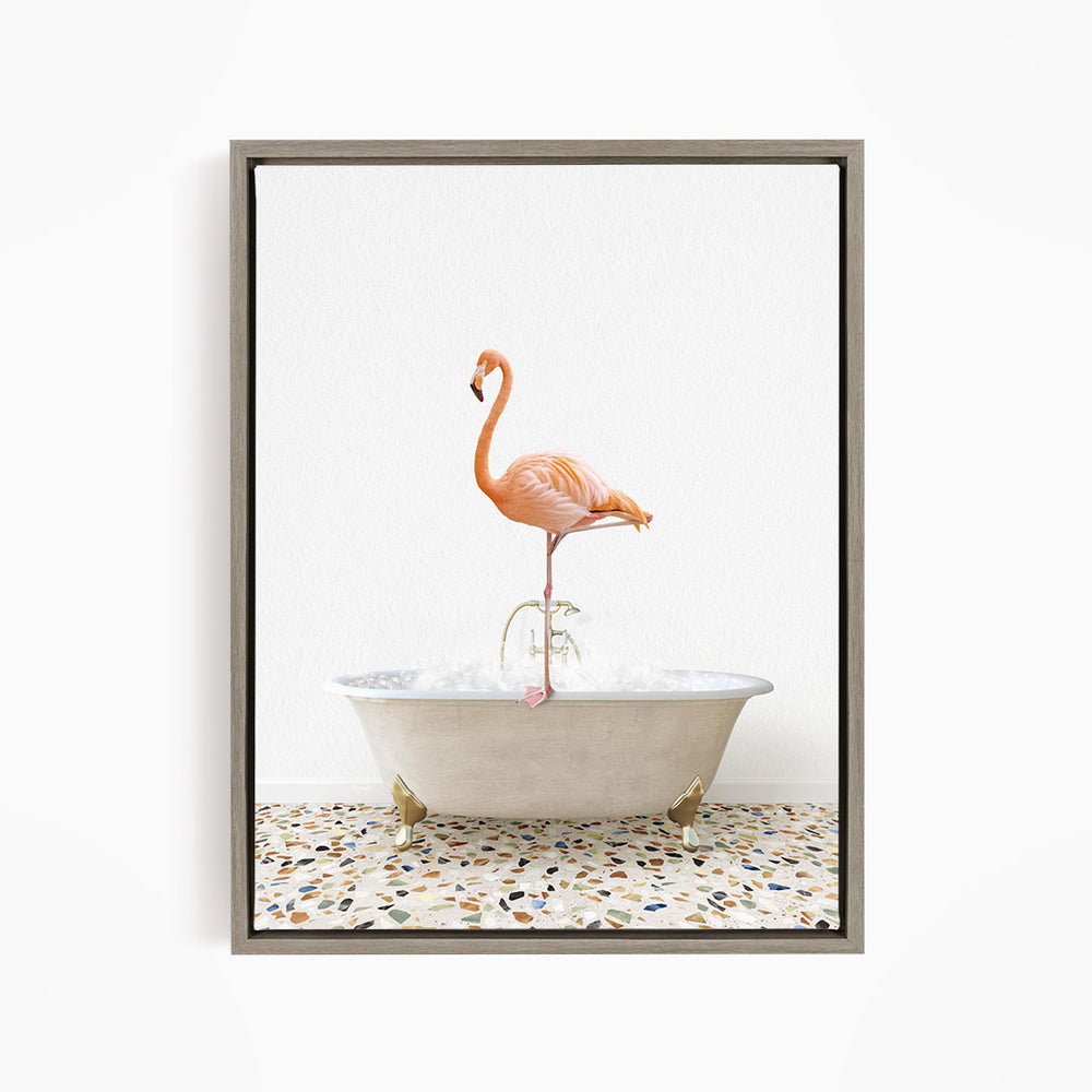A pink flamingo standing on one leg in a white bathtub filled with water.