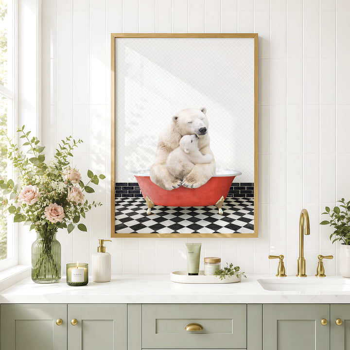 A framed image of a polar bear sitting in a red bathtub, surrounded by a black and white checkered floor and a vase of pink flowers, is displayed on a white wall above a bathroom sink.