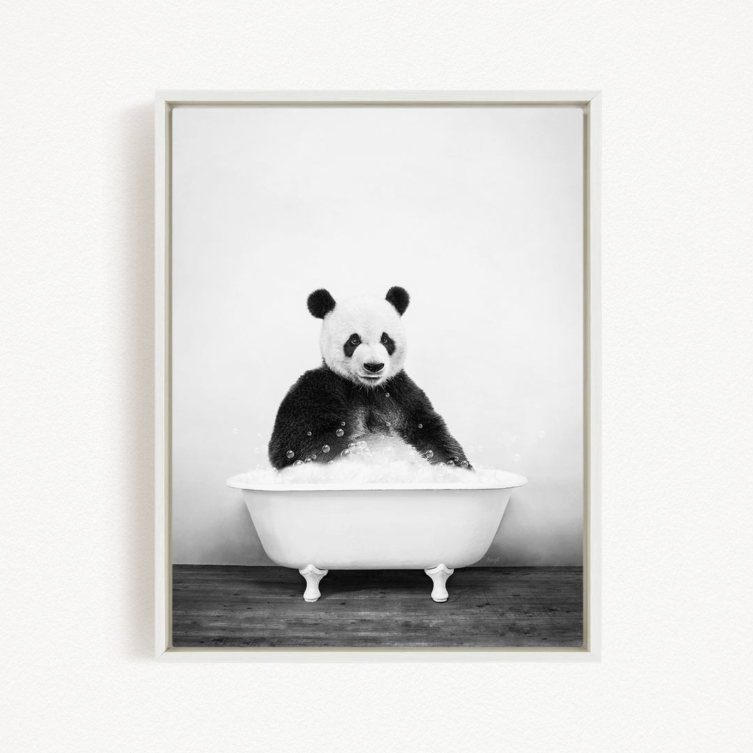 A panda bear sitting in a white bathtub filled with bubbles, appearing to enjoy a relaxing bath.