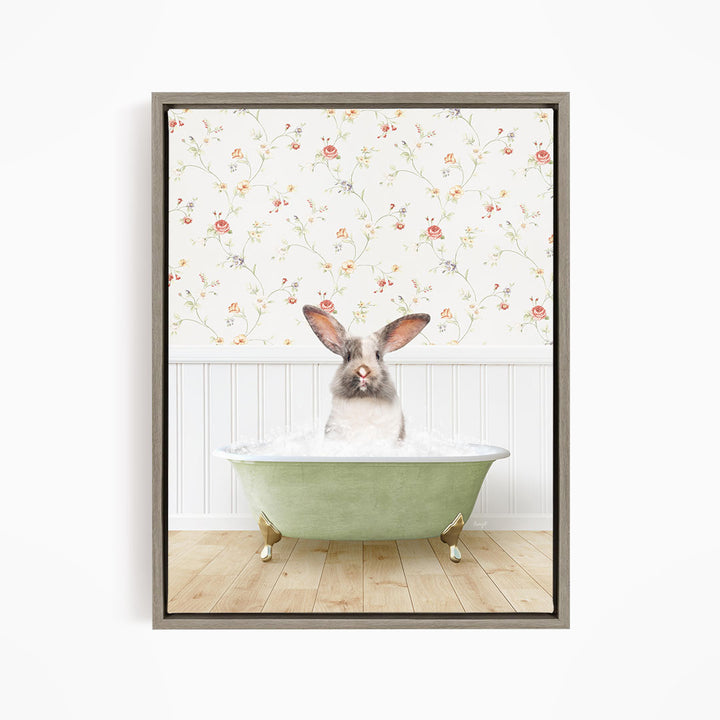 A rabbit sitting in a green bathtub filled with water, with a floral wallpaper in the background.