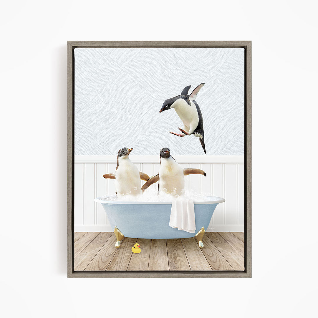 A framed image depicting two penguins sitting in a bathtub, with one penguin flying towards the other penguin.