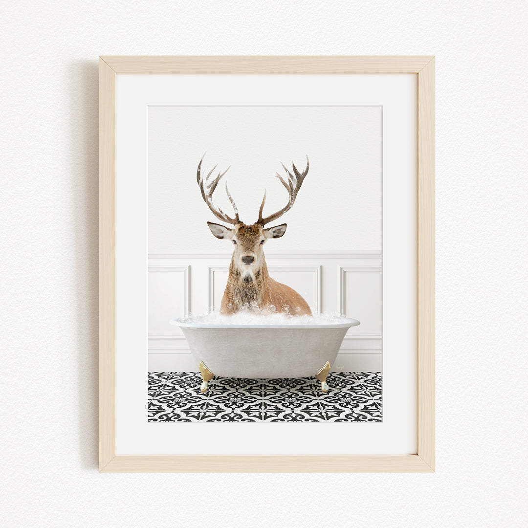 A deer with large antlers is sitting in a white bathtub filled with water, surrounded by a black and white patterned floor.