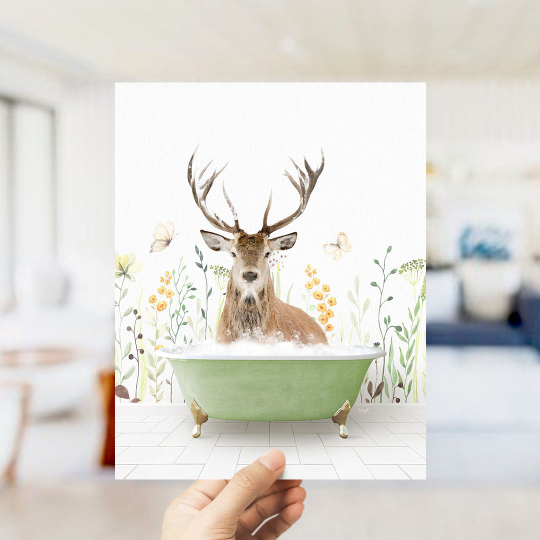 A deer with antlers is sitting in a green bathtub, surrounded by flowers and butterflies, in a room with a white wall and a blue couch.