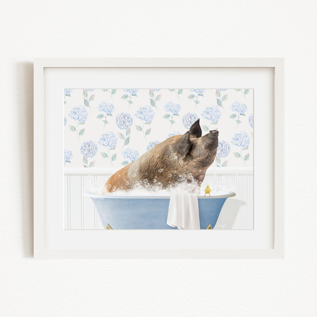 A brown pig sitting in a blue bathtub filled with bubbles, surrounded by a floral patterned wall.