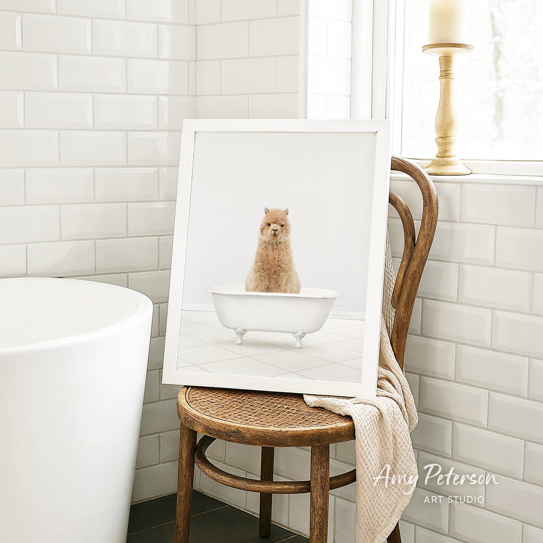 A framed image of a small brown dog sitting in a white bathtub, placed on a wooden chair in a bathroom setting.