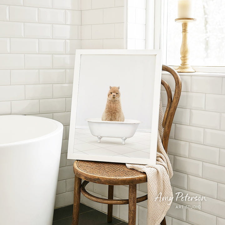 A framed image of a small brown dog sitting in a white bathtub, placed on a wooden chair in a bathroom setting.