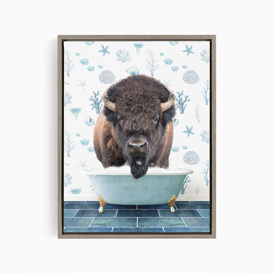 A buffalo is sitting in a bathtub filled with water, surrounded by blue and white floral patterns.