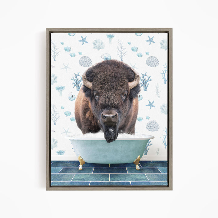 A buffalo is sitting in a bathtub filled with water, surrounded by blue and white floral patterns.