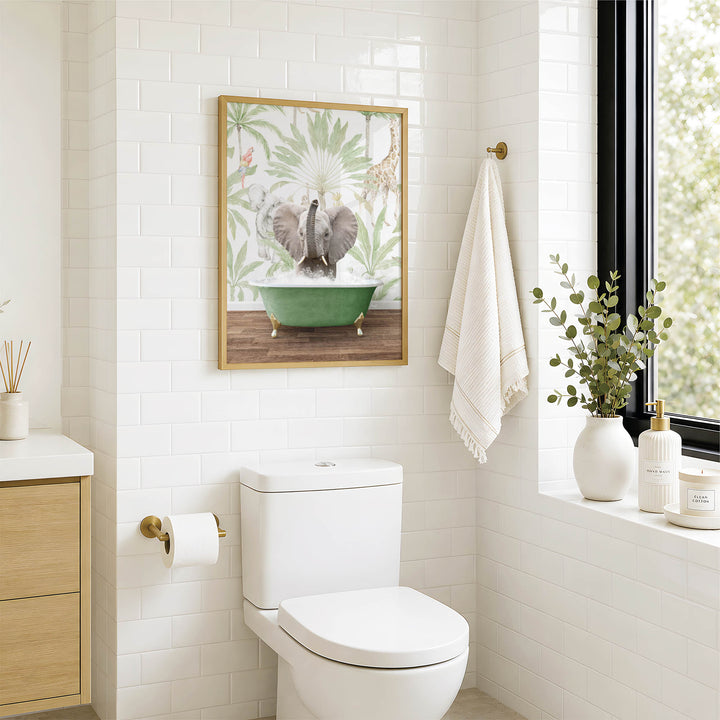 A bathroom with a white toilet, a framed picture of an elephant in a bathtub, and a window with greenery on the sill.