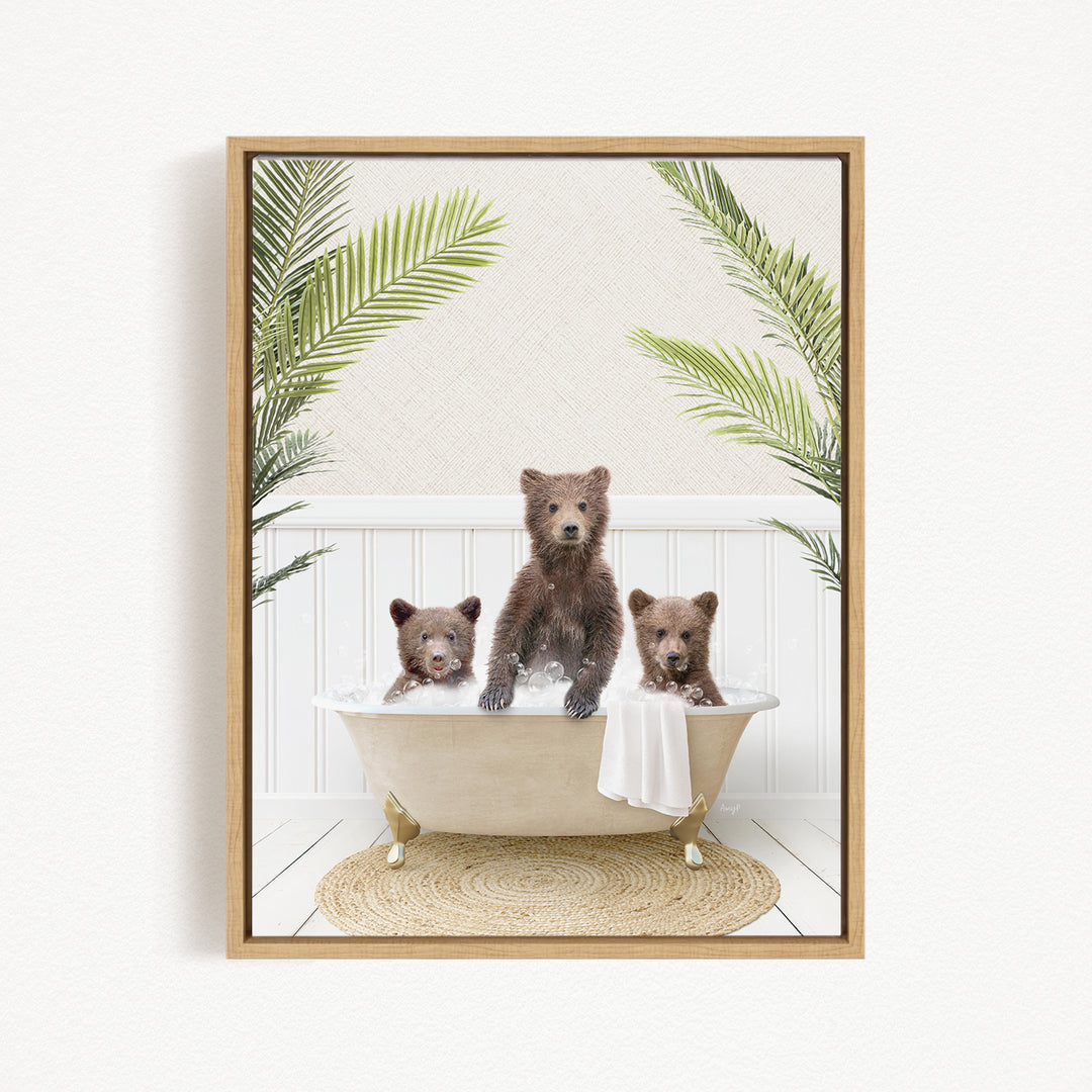 Three adorable brown bears sitting in a white bathtub, surrounded by green palm leaves, creating a whimsical and playful scene.