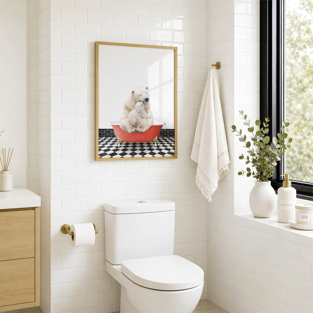 A bathroom with a white toilet, a framed picture of a polar bear sitting in a red bathtub, and a window with greenery on the sill.