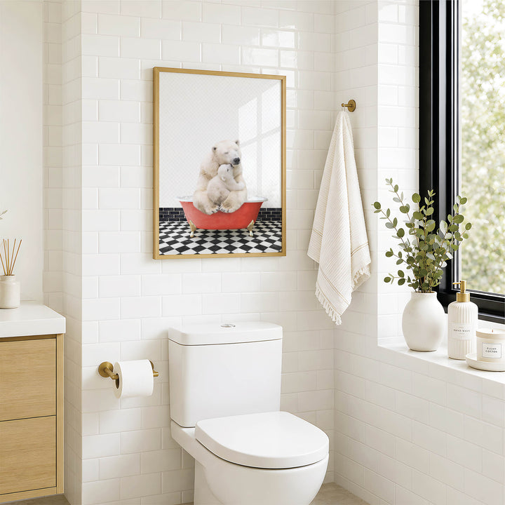 A bathroom with a white toilet, a framed picture of a polar bear sitting in a red bathtub, and a window with greenery on the sill.