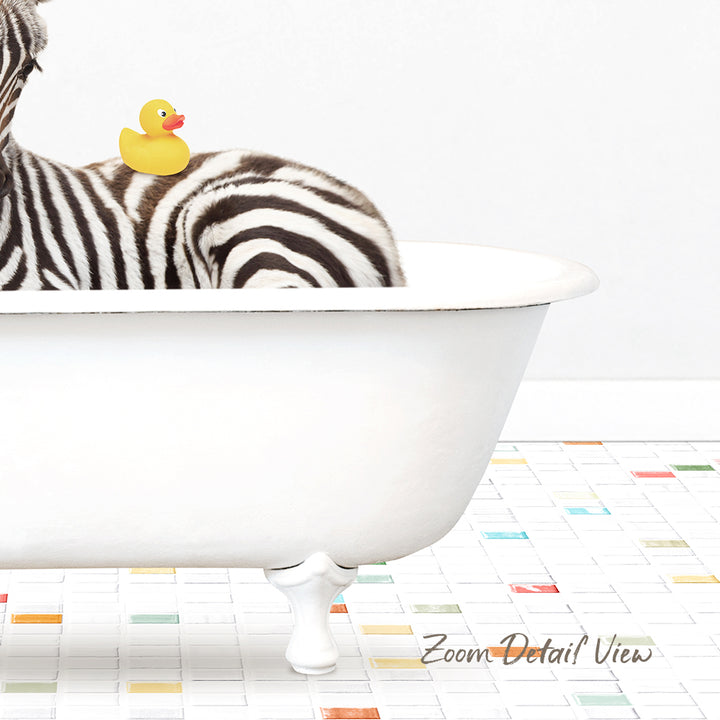 A zebra is sitting in a white bathtub, with a rubber duck perched on its back.