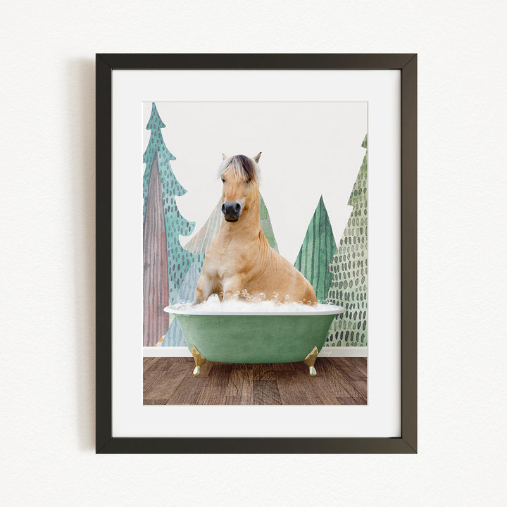 A horse is sitting in a green bathtub, surrounded by trees and a snowy landscape.