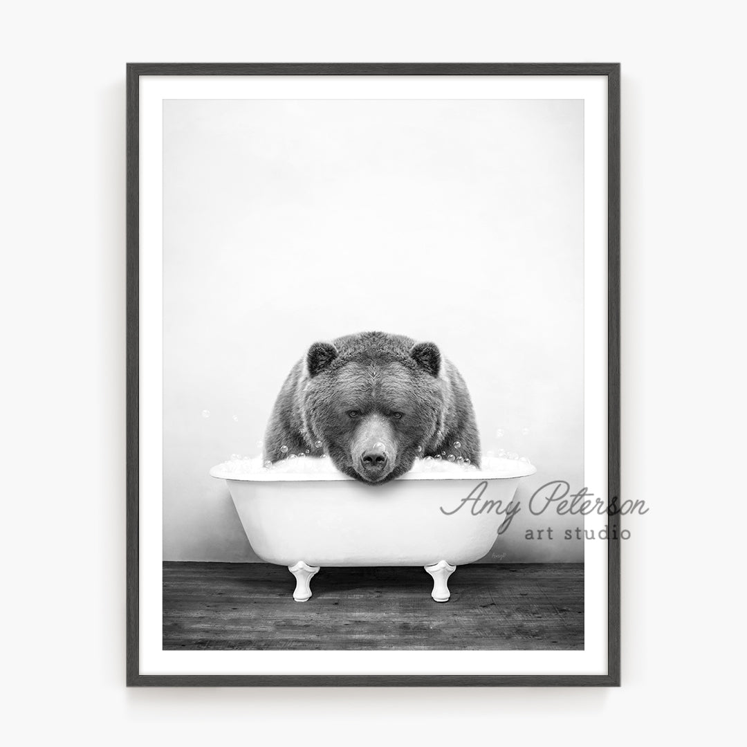 a black and white photo of a bear in a bathtub