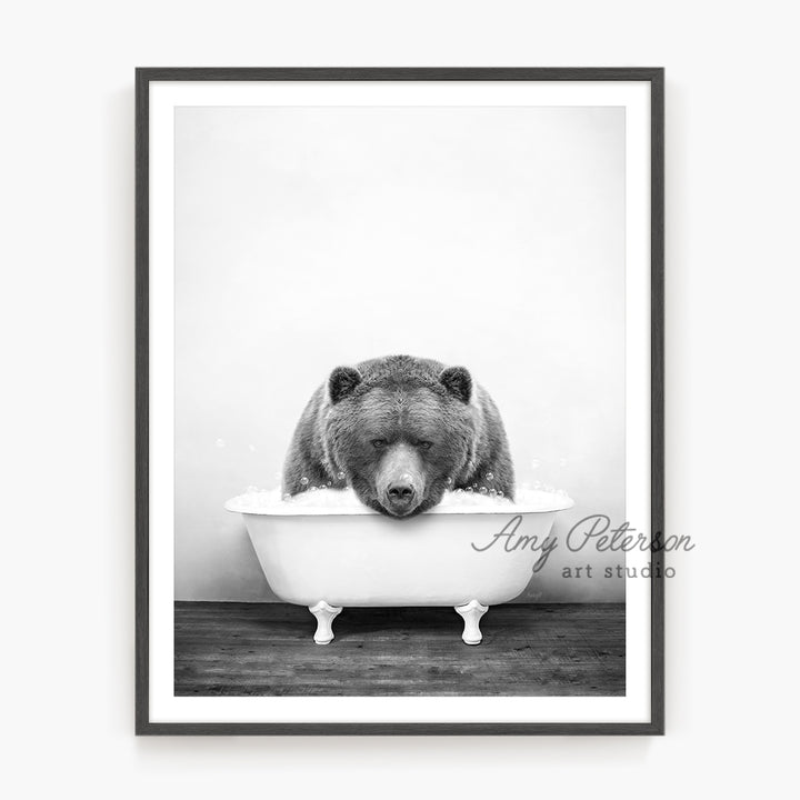 a black and white photo of a bear in a bathtub