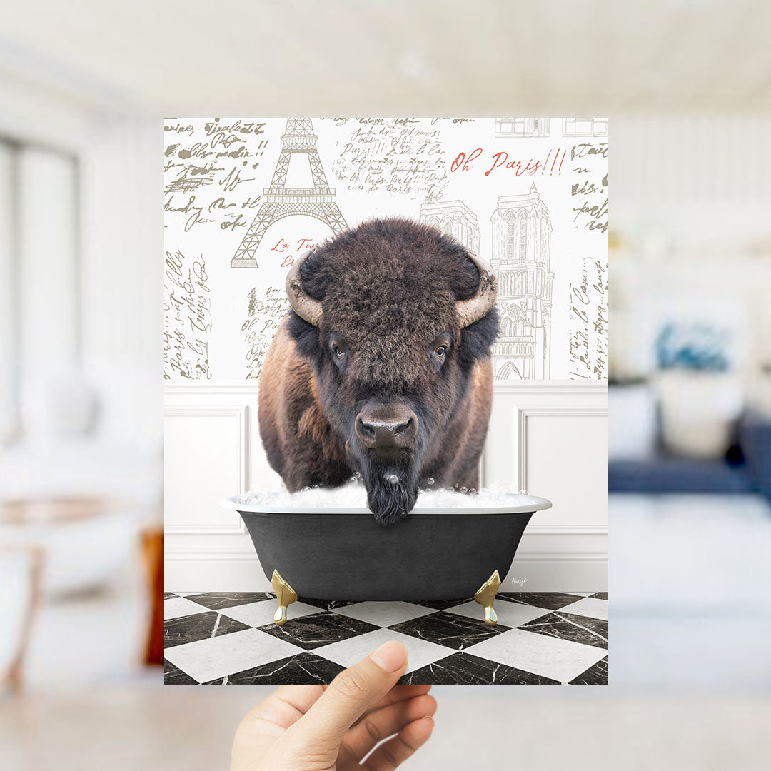 A buffalo is sitting in a bathtub filled with water, with the Eiffel Tower and Paris in the background.