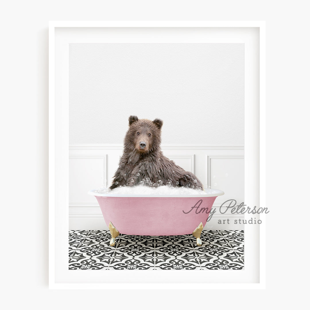 a brown bear sitting in a pink bath tub