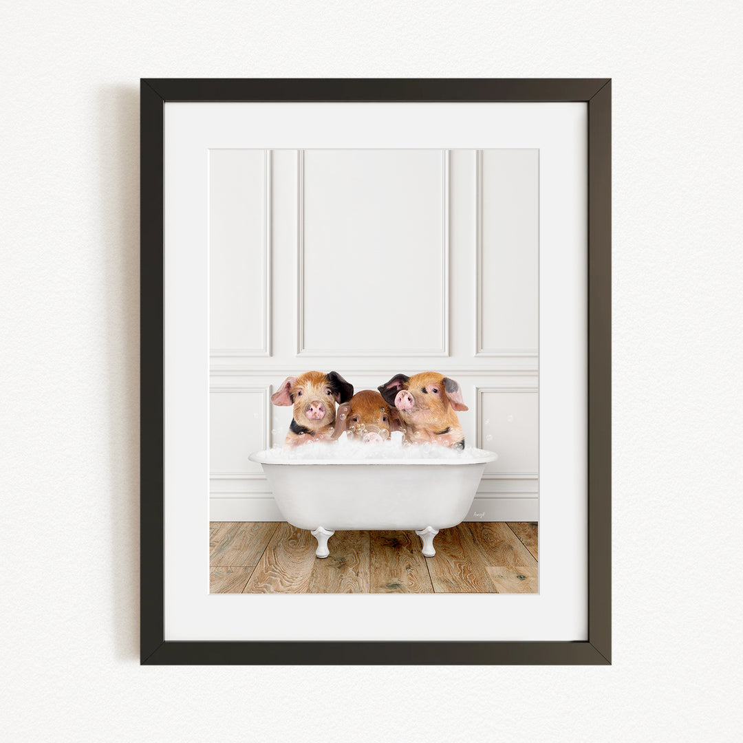 A framed image of three adorable pigs sitting in a white bathtub, enjoying a relaxing bath.