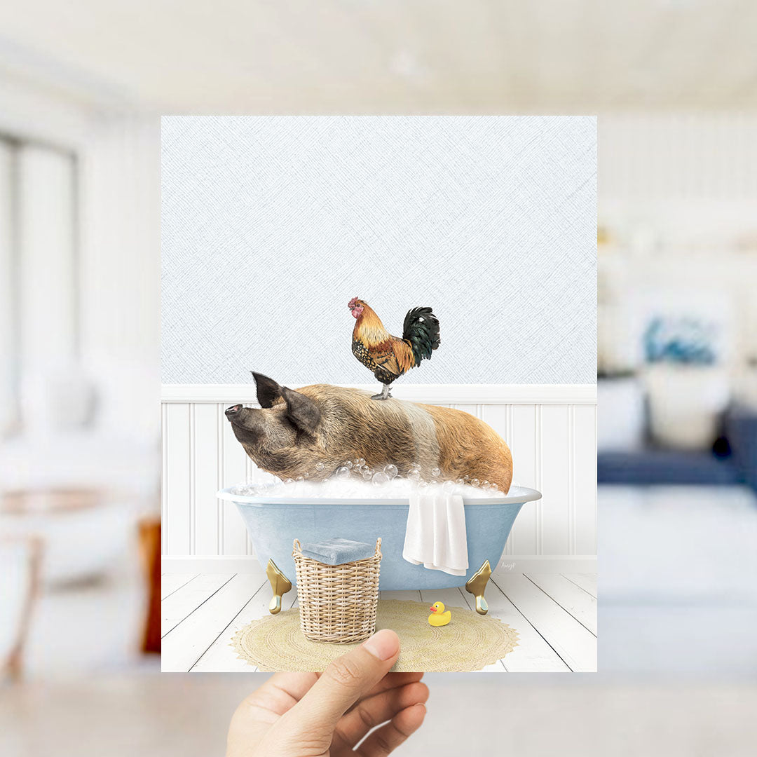 A hand holds up a collage of two images: a pig sitting in a bathtub with a rooster perched on its back, and a yellow rubber duck floating in the water.