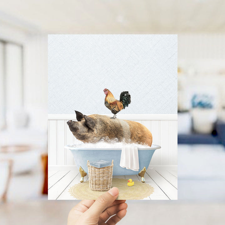 A hand holds up a collage of two images: a pig sitting in a bathtub with a rooster perched on its back, and a yellow rubber duck floating in the water.
