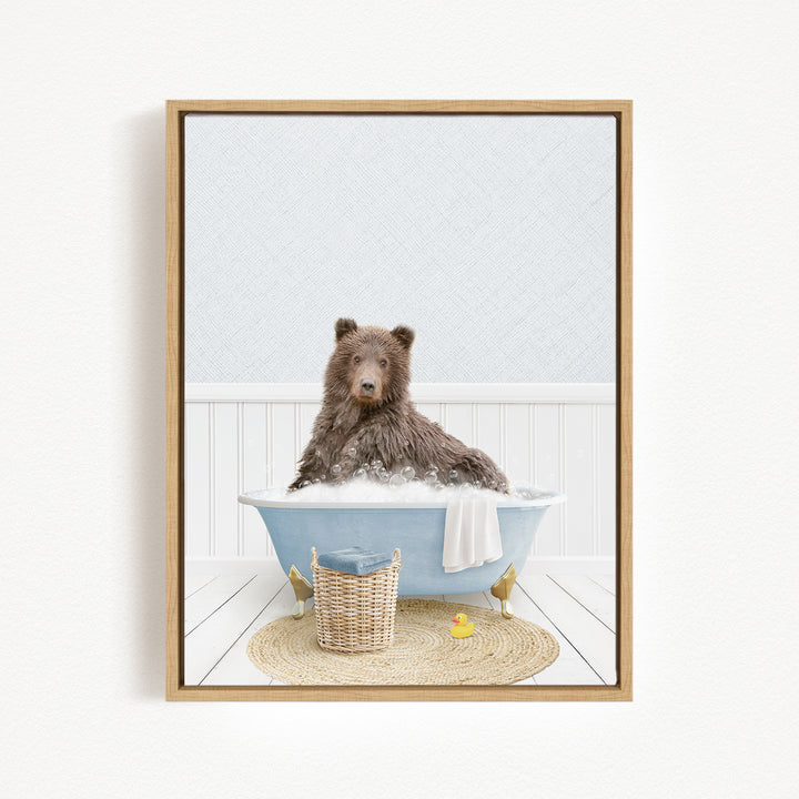 A brown bear sitting in a blue bathtub filled with water, surrounded by a yellow rubber duck and a woven basket.