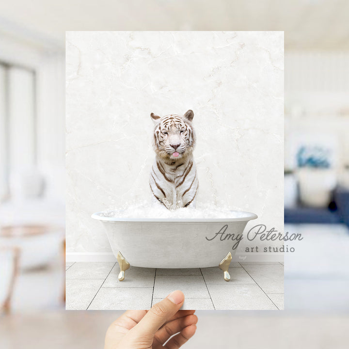 a hand holding a photo of a white tiger in a bathtub