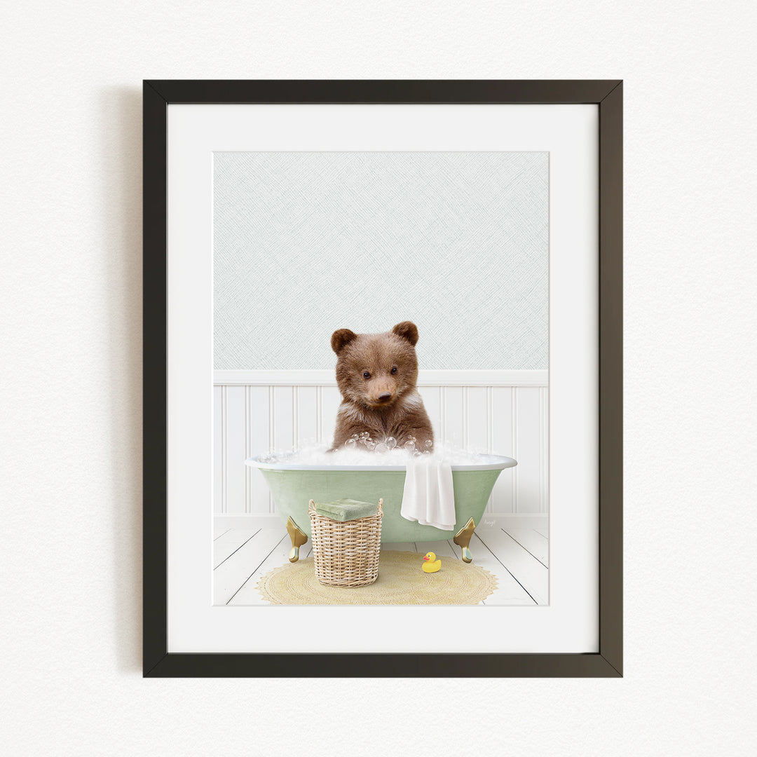 A cute brown bear sitting in a green bathtub, surrounded by a basket of toys and a yellow rubber duck.