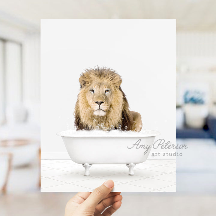 a hand holding a card with a picture of a lion in a bathtub