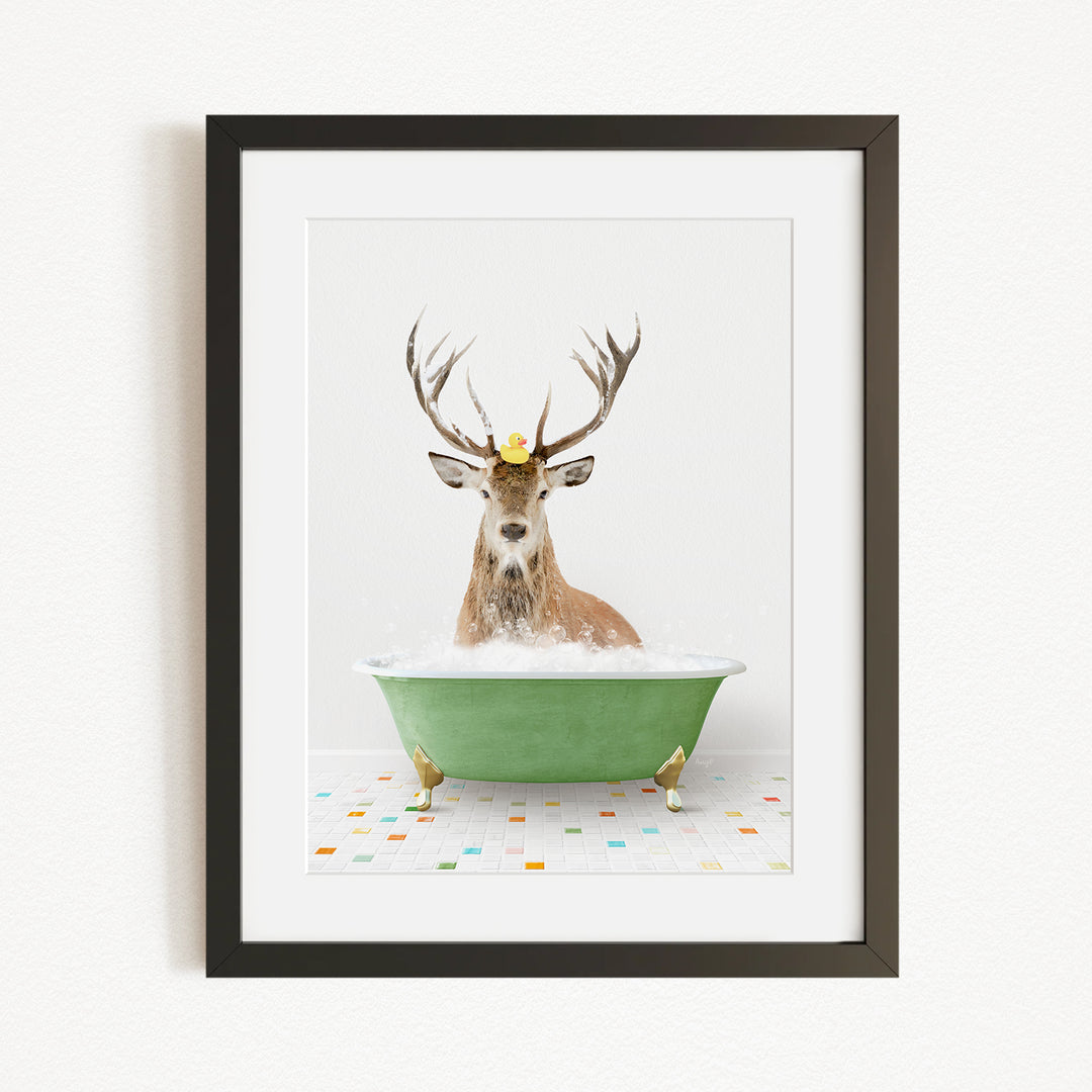 A deer with antlers is sitting in a green bathtub filled with water, with a yellow rubber duck floating on its head.