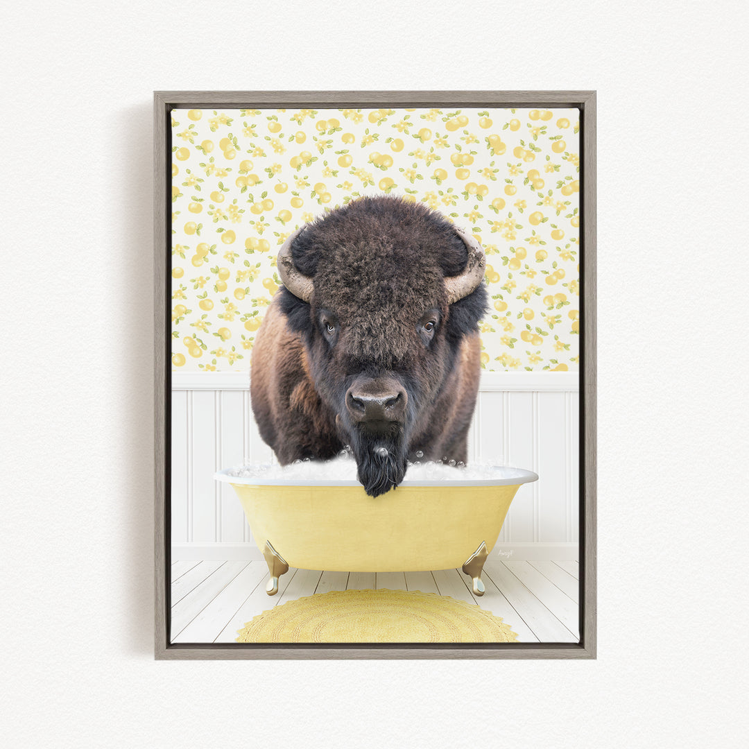 A buffalo with a long beard is sitting in a yellow bathtub, looking directly at the camera.