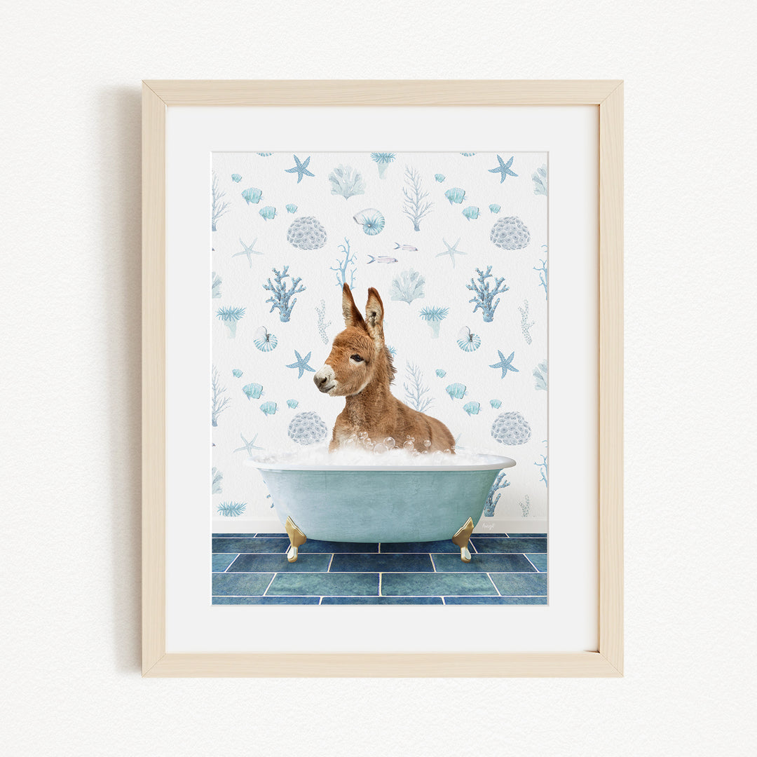 A donkey is sitting in a bathtub filled with water, surrounded by a blue and white patterned background.