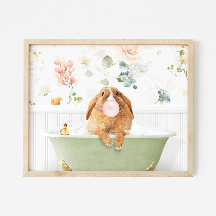 a brown bunny sitting in a bathtub with a bubble in it's mouth