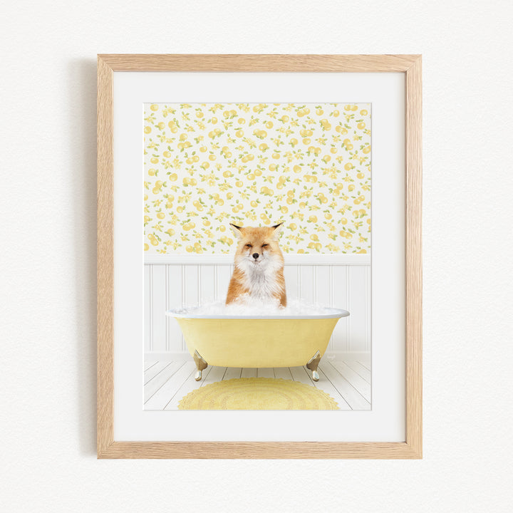 A framed image depicting a fox sitting in a yellow bathtub, with a yellow floral pattern on the wall behind it.