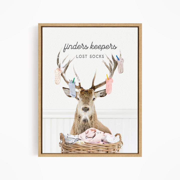 A deer with antlers holding socks in its mouth, standing in a basket filled with clothes.