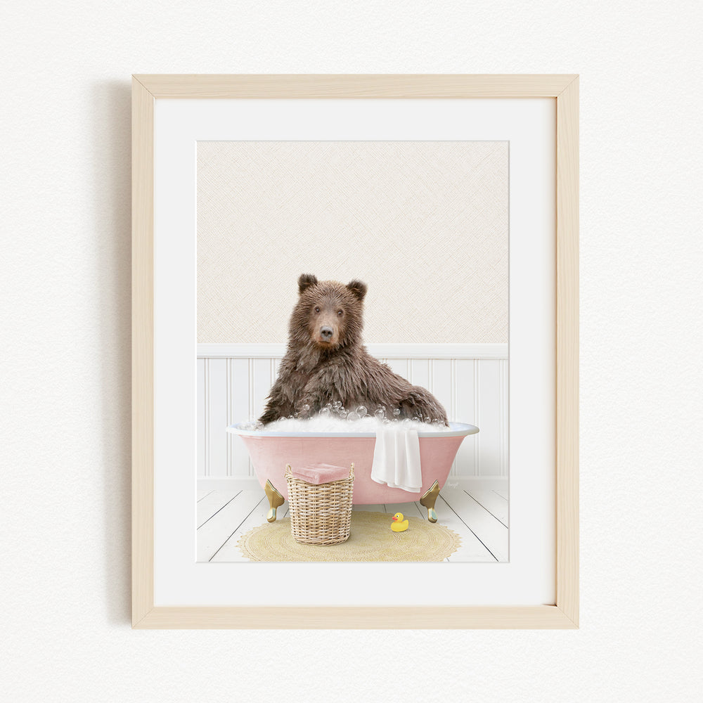 A brown bear sitting in a pink bathtub filled with water, surrounded by rubber ducks.