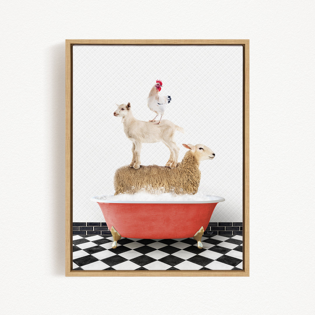A framed image depicting a sheep standing on a goat's back, with a rooster perched on top of the goat, all atop a red bathtub filled with bubbles.