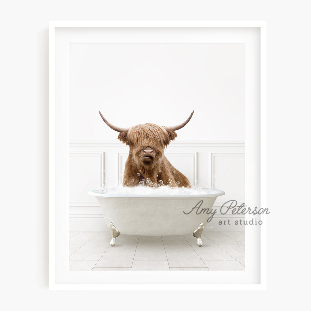 a brown dog sitting in a bathtub with long horns