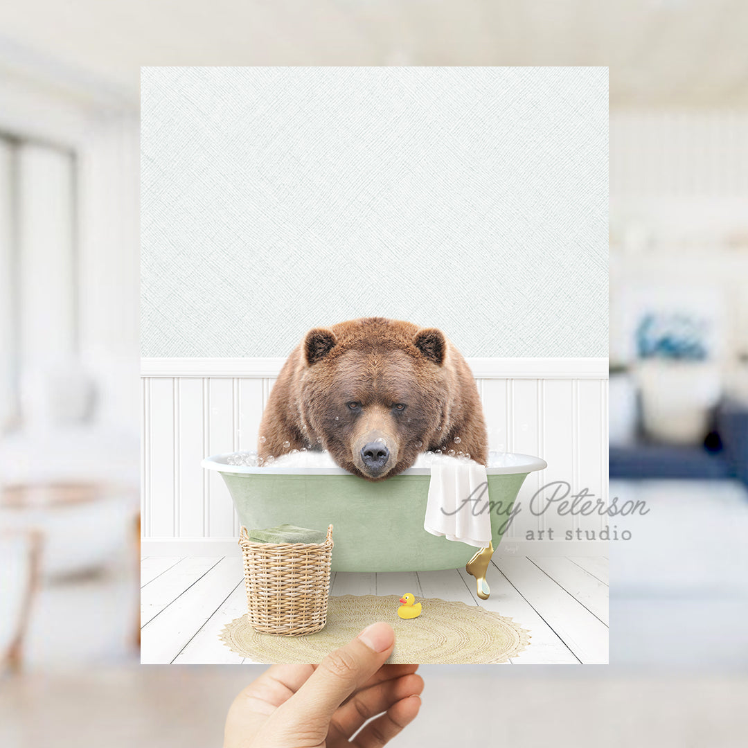 a person holding up a picture of a bear in a bathtub