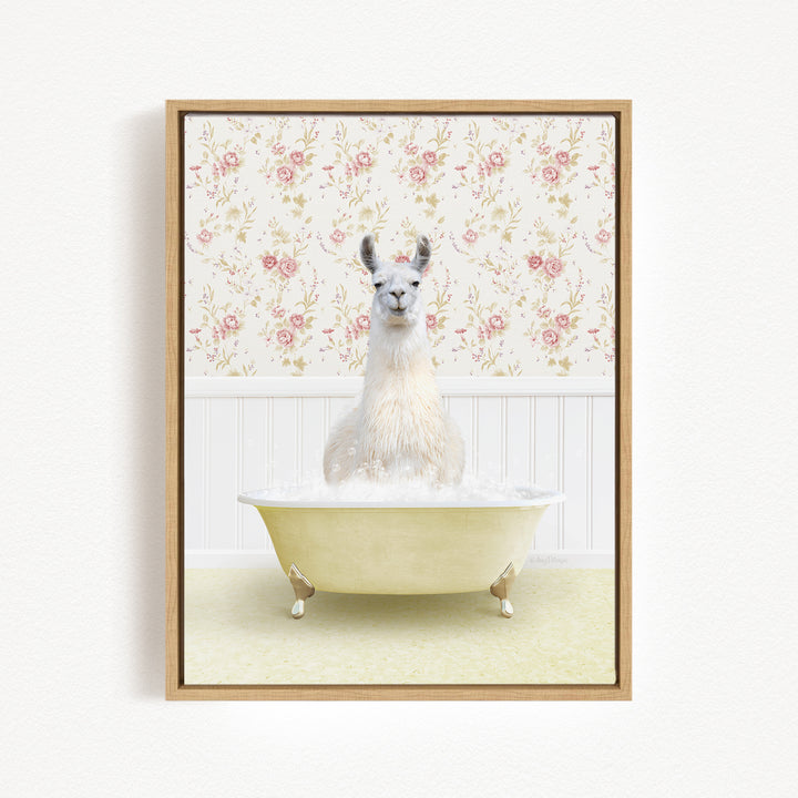 A white llama sitting in a yellow bathtub filled with bubbles, against a floral wallpaper background.