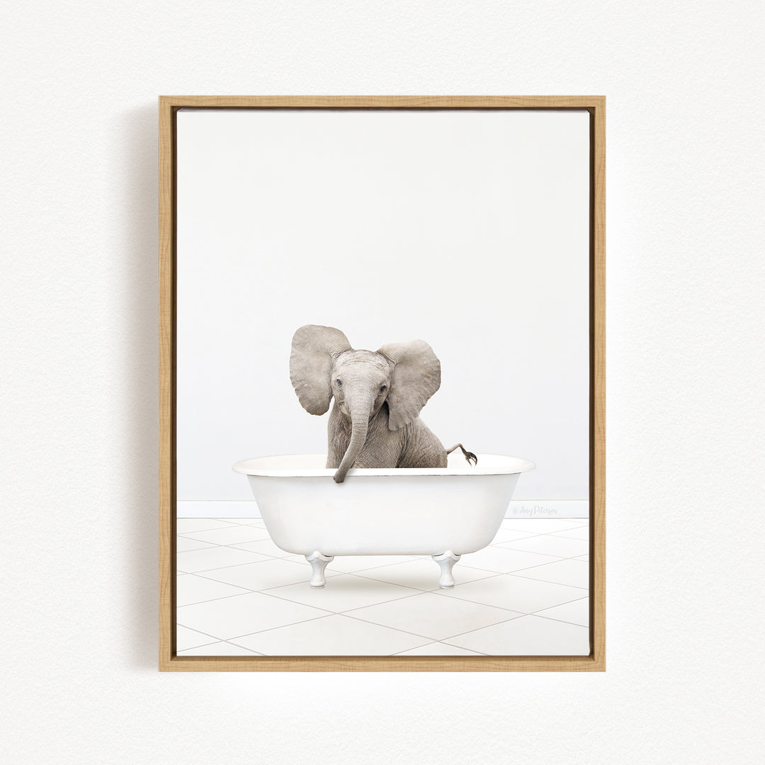 A baby elephant sitting in a white bathtub, with its trunk raised in the air.